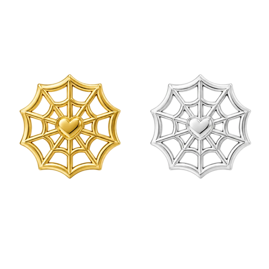 Two spiderweb-shaped stud earrings on a white background, one in yellow gold and one in silver, both with a heart in the center.